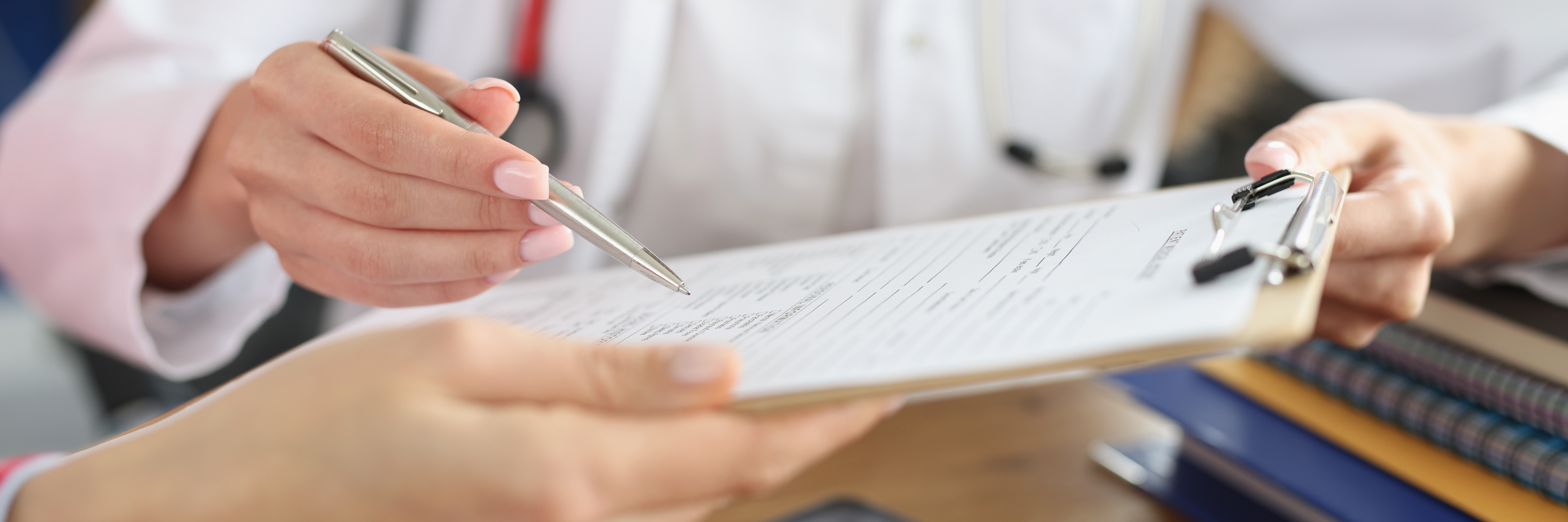 Female,Doctor,And,Patient,Signing,Medical,Contract