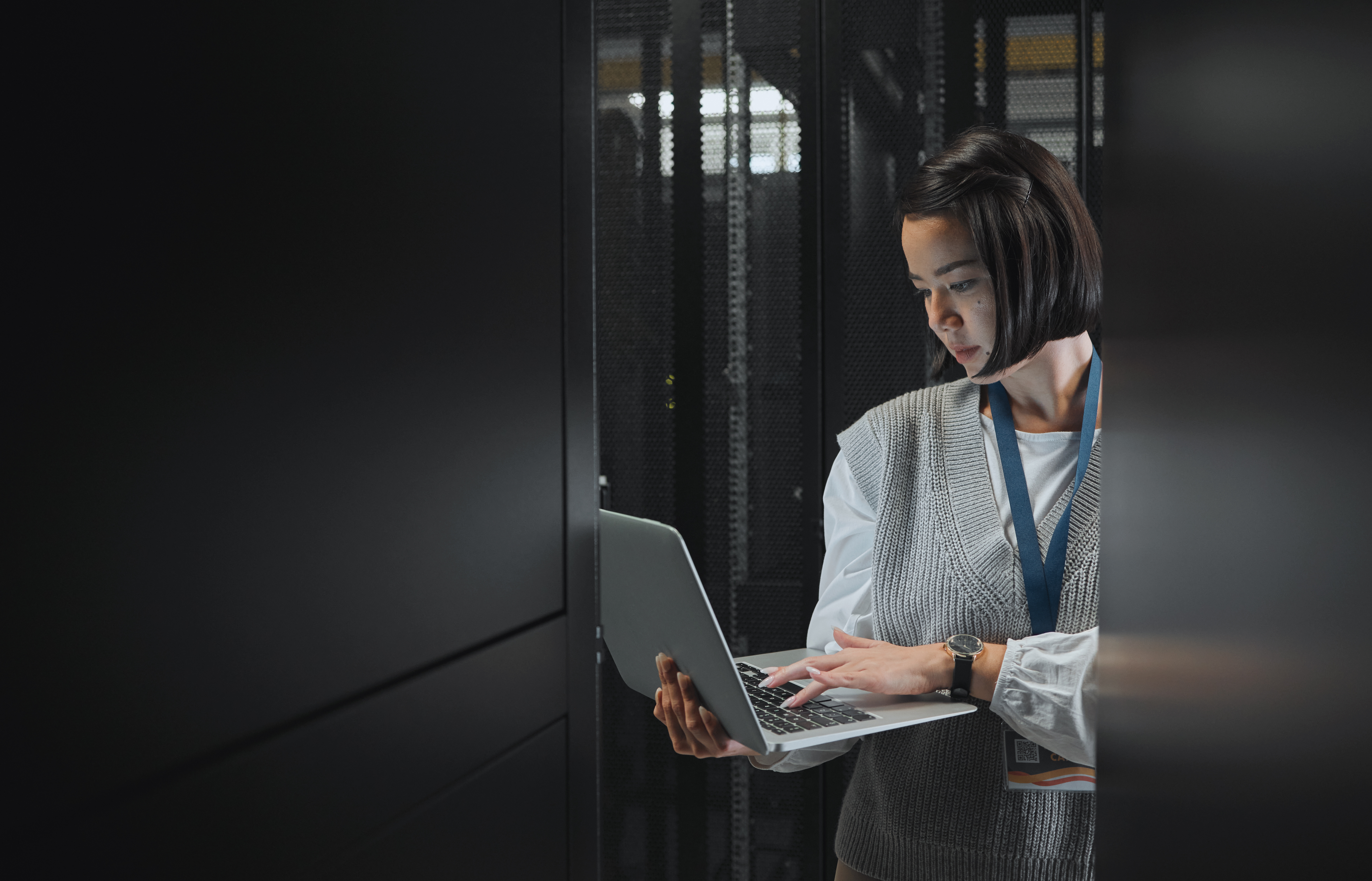 woman-with-laptop-datacenter-and-information-tech-2023-11-27-04-59-19-utc