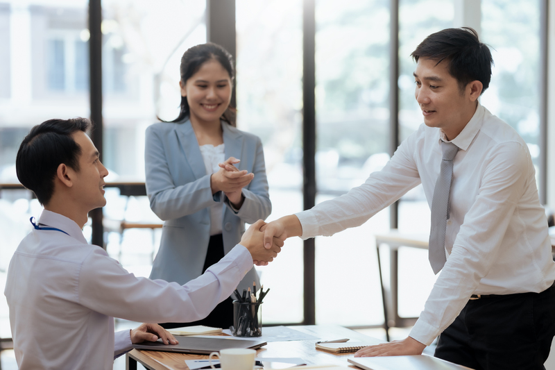 Asian businessman handshake with partner to celebration partners