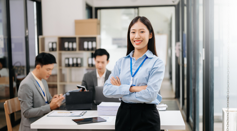 Young attractive Asian female office worker business suits smili